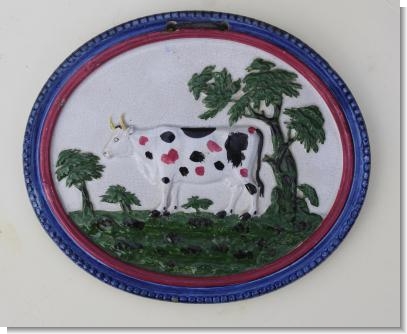 PEARLWARE COW PLAQUE decorated in over glaze colours, c.1820-25